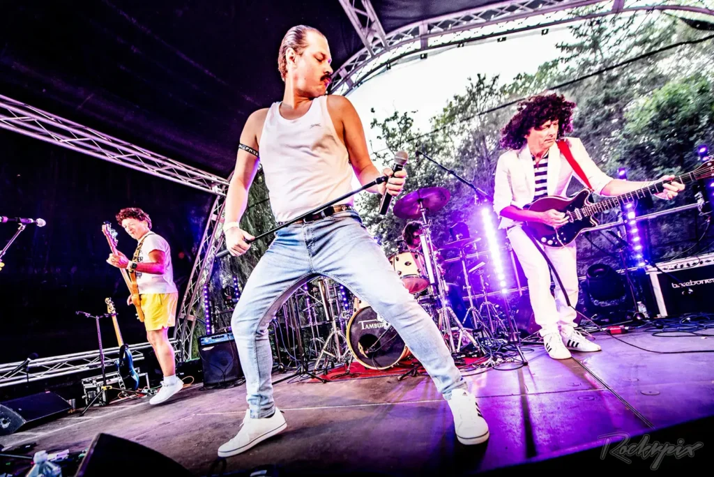 Queen Champions performing live on an outdoor festival stage