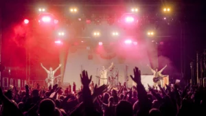 Queen Champions performing live to a large crowd at a festival