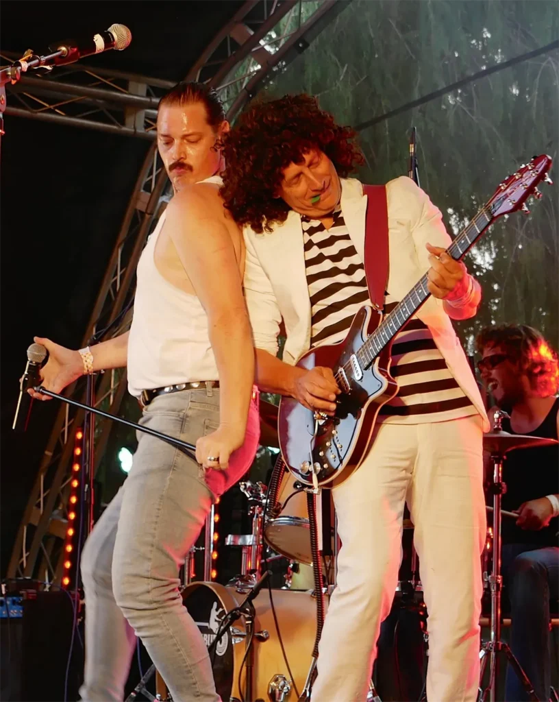 Chris as Freddie Mercury and Matt as Brian May performing with Queen Champions
