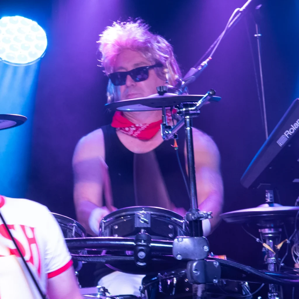 Dean of Queen Champions performing as Roger Taylor on drums