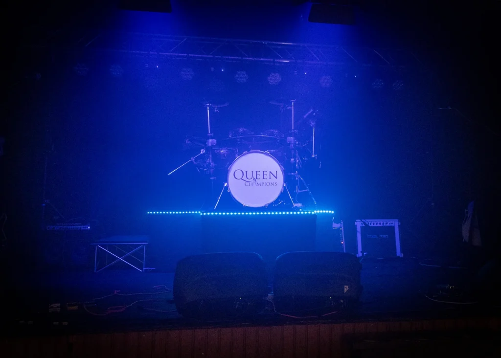 Queen Champions stage and drum kit lit before a live show